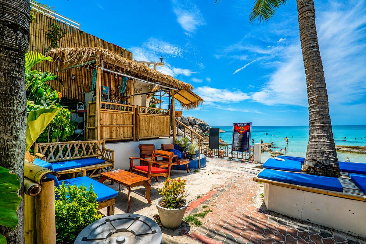 The bamboo beach bar and sun loungers at the water's edge on Silver Beach