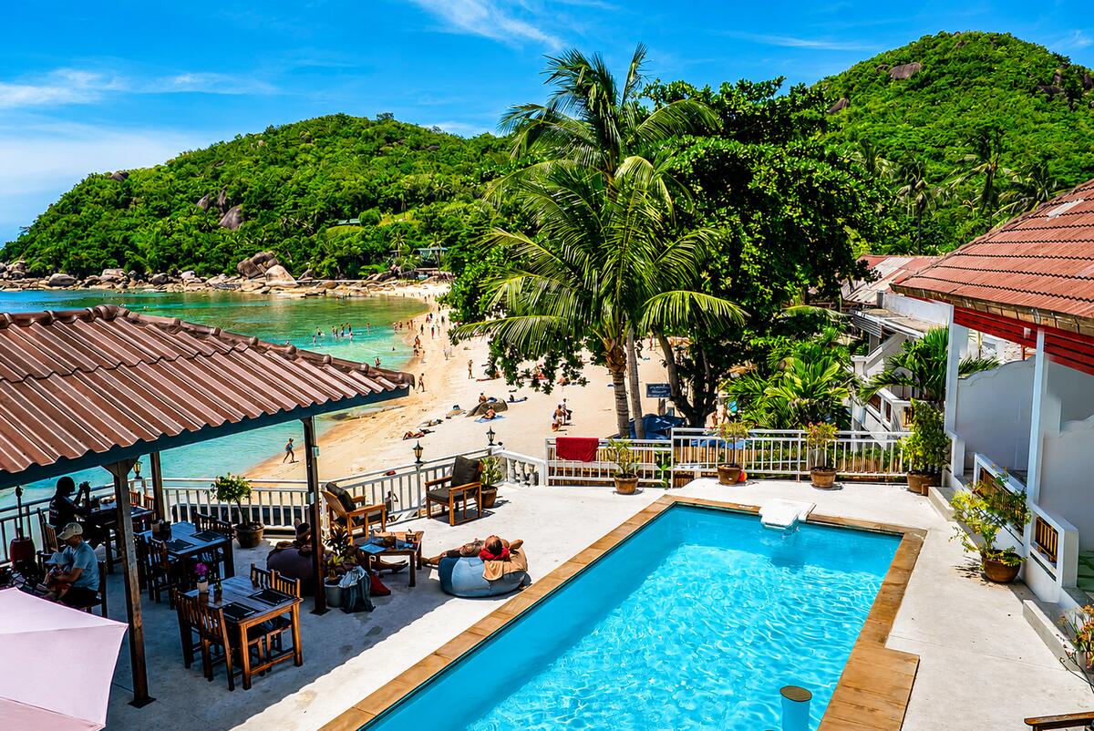 The resort pool and restaurant terrace above Silver Beach, looking across the bay